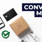 A clean overhead flat-lay product photograph showing a smartphone with an online checkout screen, a credit card, a branded product package, and a green checkmark stamp arranged on a white background with dramatic shadow lighting